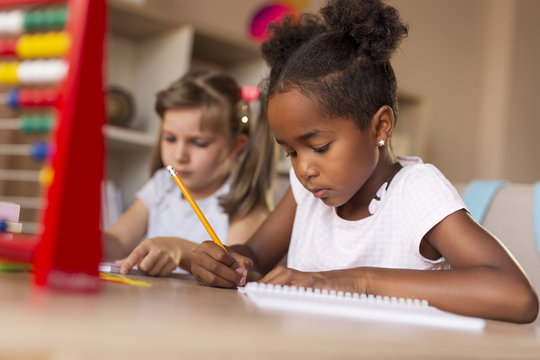Little girls doing math homework - Powered by Adobe