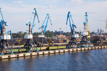 Fototapeta premium Cargo port, ships and river Daugava. Big ships, old buildings.