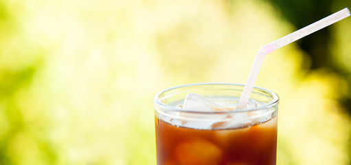 close-up of an ice drink in a glass cup on a natural background