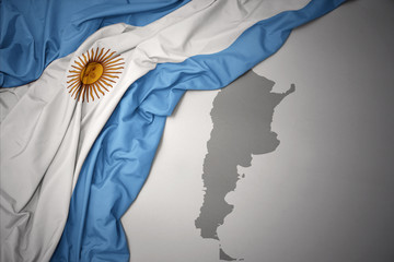 waving colorful national flag and map of argentina.