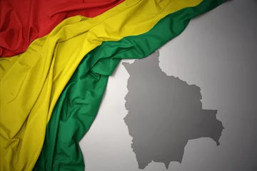 Fotobehang waving colorful national flag and map of bolivia. © luzitanija