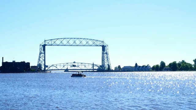Duluth Minnesota Aerial Lift Bridge and Canal to Harbor with pontoon in harbor on a sunny morning