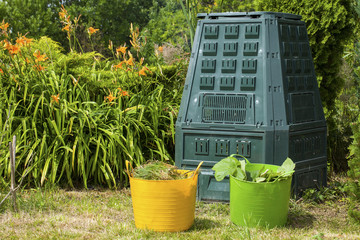 Compost bin and mulch in a  summer garden