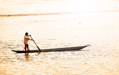 Embera Indian rowing his canoe across the Chagres river in Panama