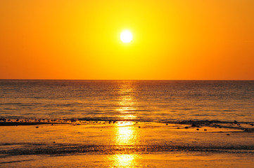 Bright yellow and orange sunrise at a beach in Panama