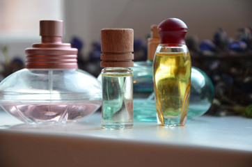 Panoramic banner or header of fresh purple lavender with flacons of essential oil for aromatherapy, alternate medicine and perfumery