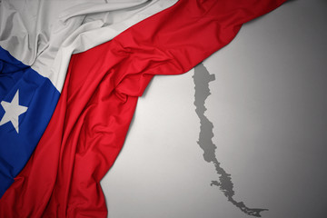 waving colorful national flag and map of chile.