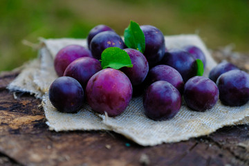 Plums on an old wooden table