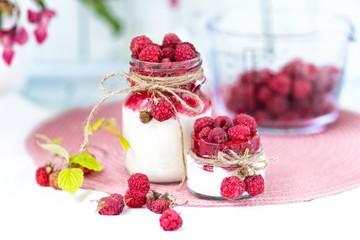 Obraz na płótnie Canvas breakfasts, desserts. Yogurt with raspberry syrup and raspberry berries 