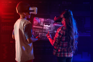 More information. Cheerful emotional kids putting their hands up and wearing virtual reality glasses while having fun with their new educational program