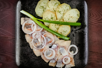 Salted herring slice with boiled potato