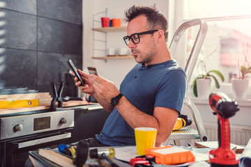Men shopping online during kitchen renovation