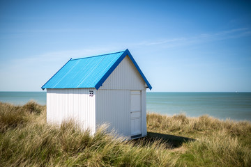 Colorful wooden beach cabins in the dunes, Gouville-sur-Mer, Normandy, France - 214140377
