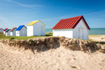 Colorful wooden beach cabins in the dunes, Gouville-sur-Mer, Normandy, France - 214140705