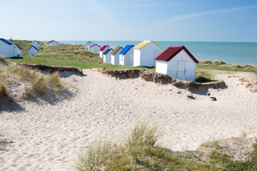 Colorful wooden beach cabins in the dunes, Gouville-sur-Mer, Normandy, France