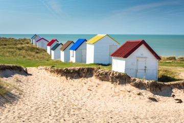 Colorful wooden beach cabins in the dunes, Gouville-sur-Mer, Normandy, France - 214140723