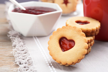 Traditional Christmas Linzer cookies with sweet jam on table