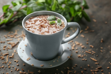 Cup of hot mint chocolate on table