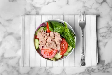 Fotobehang Delicious salad with canned tuna in bowl on marble background, top view © New Africa