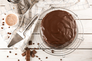 Cooling rack with delicious chocolate cake on table