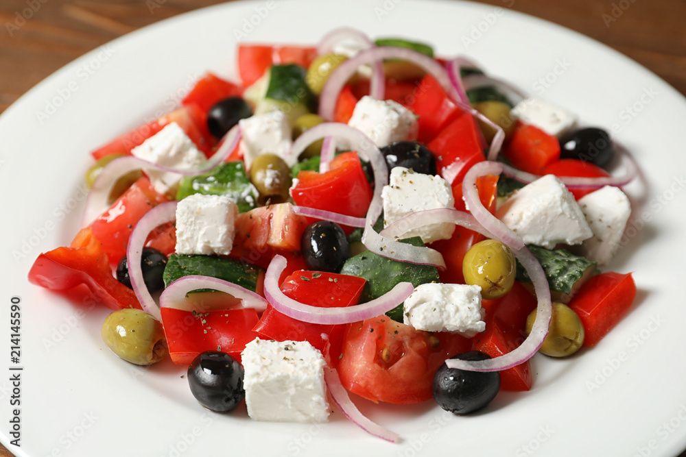 Wall mural fresh salad with delicious cheese and olives on plate, closeup