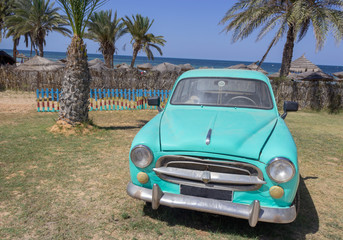 Old lime machine on the background of palm trees
