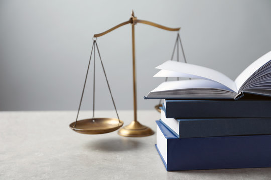 Scales of justice and books on table. Law concept