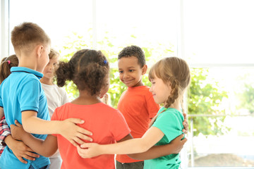 Little children making circle with hands around each other indoors. Unity concept