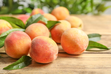 Fototapeta na wymiar Fresh sweet ripe peaches on wooden table