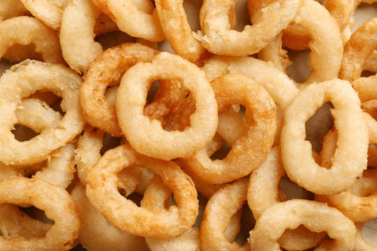 Freshly cooked onion rings as background