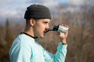 Man in Aqua Coloured Shirt Holding Binoculars Looking Confident - 214147708