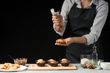 The chef prepares sweets, on a dark background with an empty space