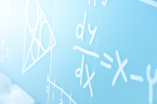 Handwriting Physics Equations sign on the college white board - Powered by Adobe