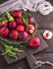 red ripe peaches nectarine in an iron plate