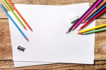 school draw table. White paper with wooden crayons. 