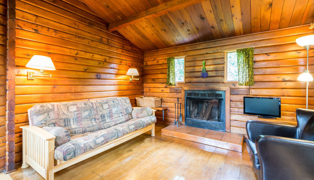 Cozy interior of a living room in a rustic log cabin.