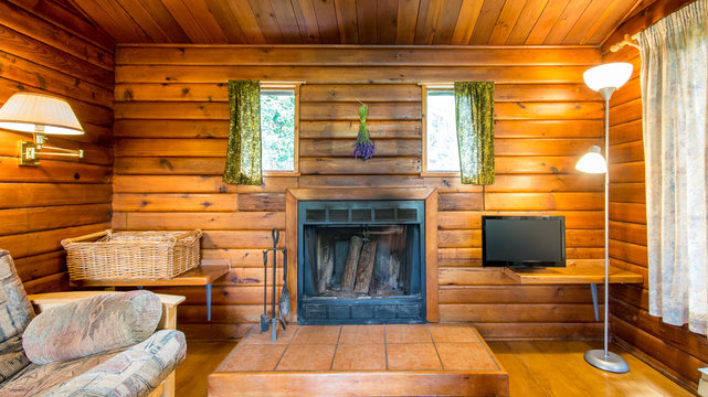 Cozy interior of a living room in a rustic log cabin.