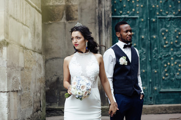 Wedding day. Stylish african groom and his pretty bride.