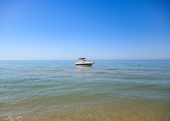 A small boat yacht in the sea near the shore