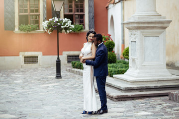 Wedding day. Stylish african groom and his pretty bride.