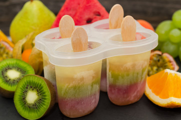Homemade popsicles with fresh fruits. Homemade organic healthy fruit lolly pops 