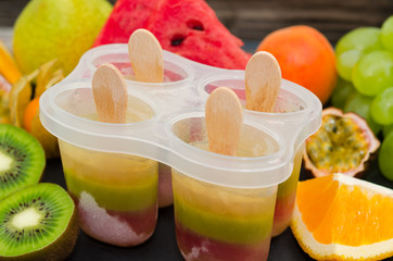 Homemade popsicles with fresh fruits. Homemade organic healthy fruit lolly pops 