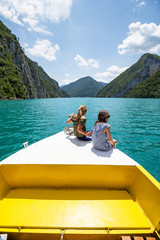 Two little girls enjoying trip on a boat