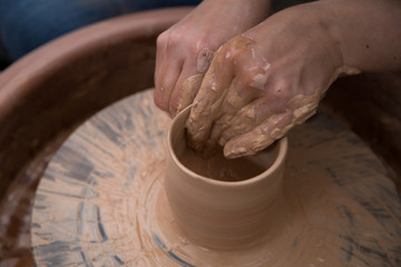 Ceramic artist working on a pottery wheel