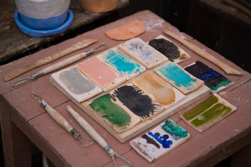 Pottery tools, loops and fettling knives. Colour glase samples and chart.