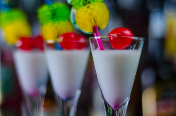 exotic drink based on Malibu rum and other ingredients, cocktail prepared by the bartender