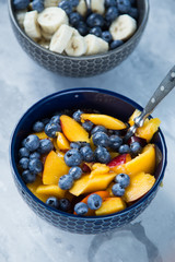 Breakfast bowl with oat flakes and fruits and berries like blueberries , nectarines and bananas