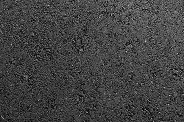 Texture of fresh hot asphalt. Black background resembling anthracite.