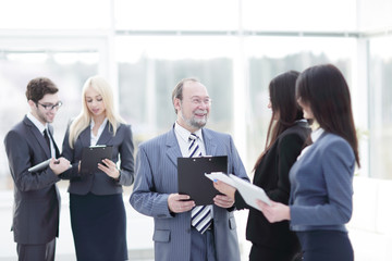 close up.group of business people standing in lobby of office.