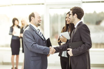handshake business partners before a business meeting
